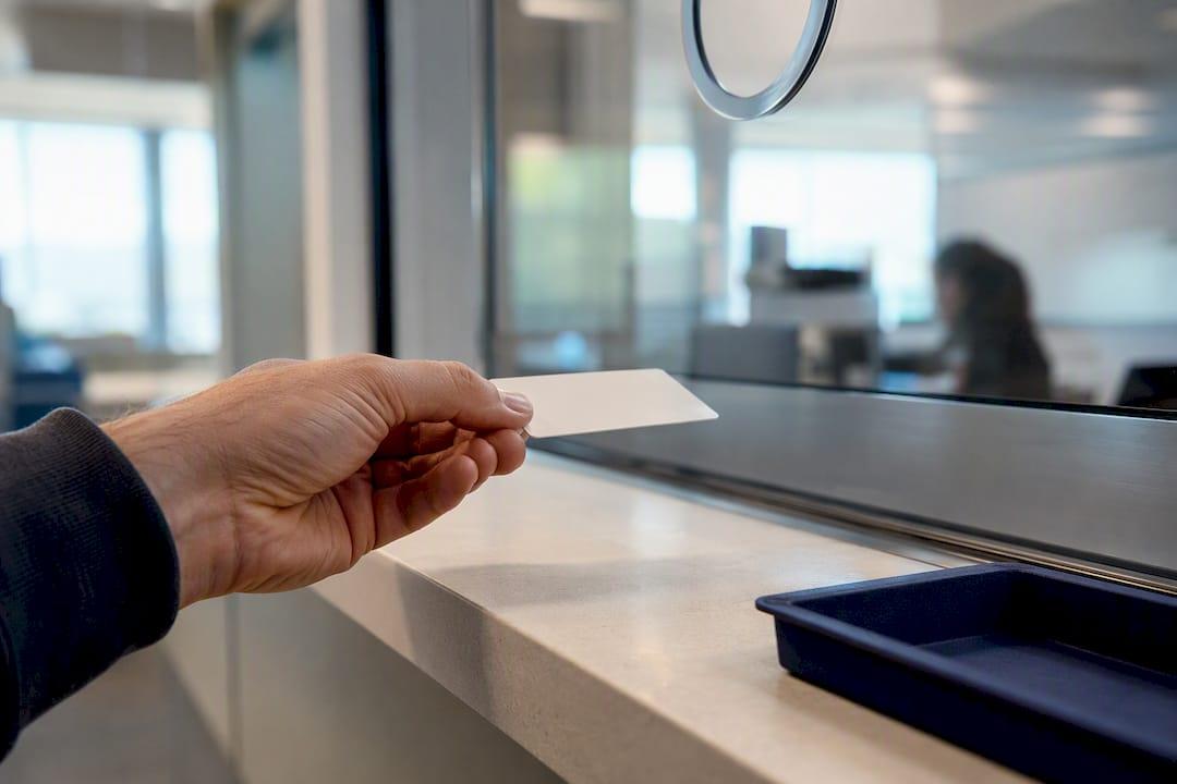 Granite Criminal Defense Driver Submitting License At Service Window